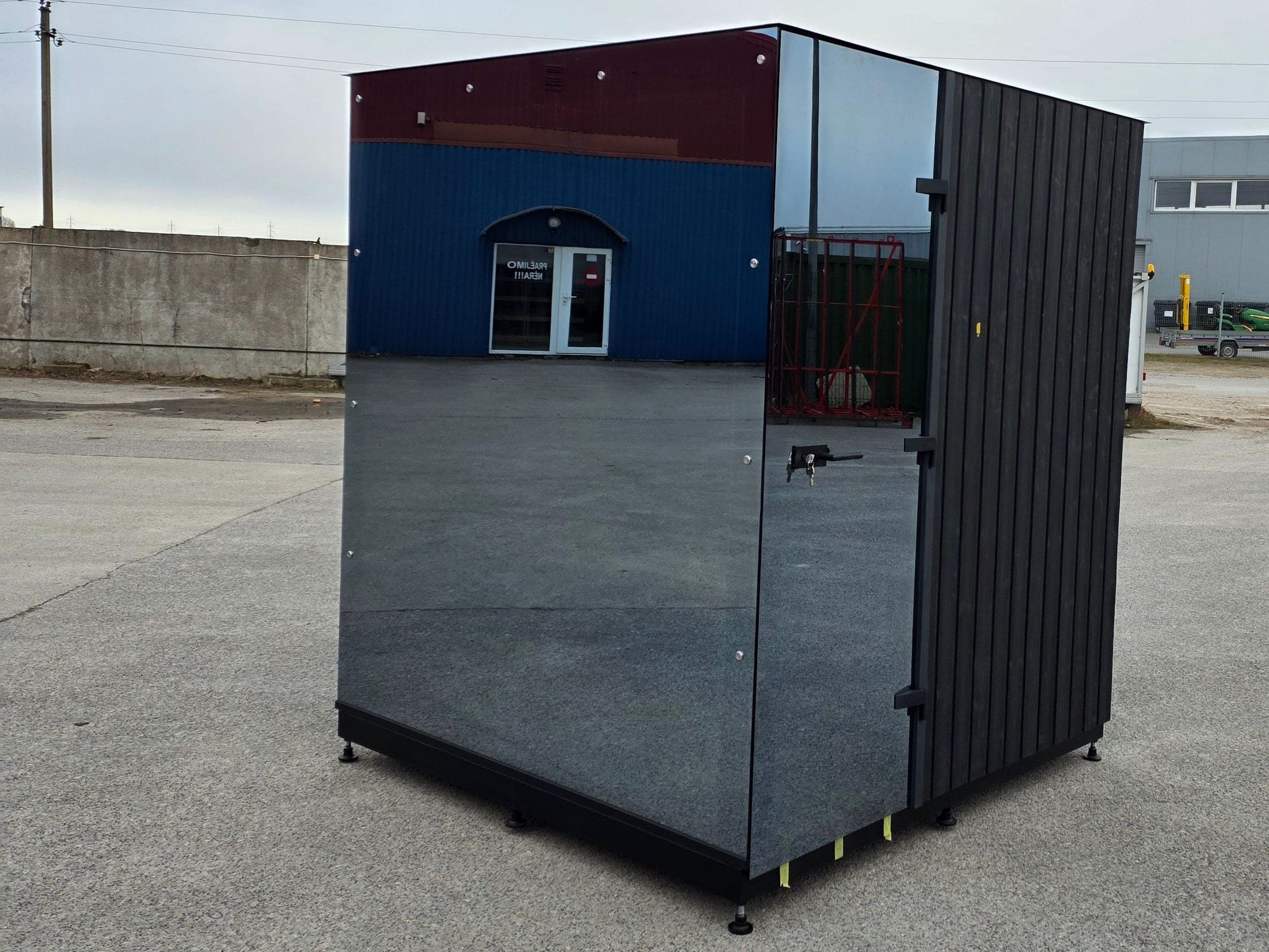 Wood Architects cube sauna with mirror-effect glass and a glass door, photographed at our factory